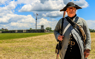 Militiaman with Fort Stanwix in the background in Fort Stanwix NM