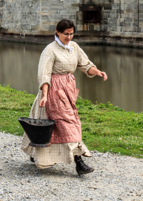 Woman transporting water for cooking in Fort Delaware State Park