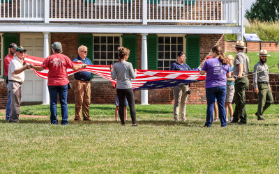 Volunteers assist with the morning flag change in Fort McHenry NM and HS