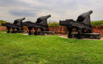 Large cannons mounted on an exterior wall in Fort McHenry NM and HS