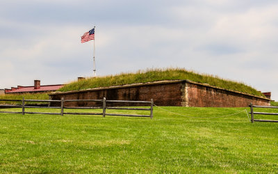 Fortress walls with the fifteen-star flag flying above in Fort McHenry NM and HS