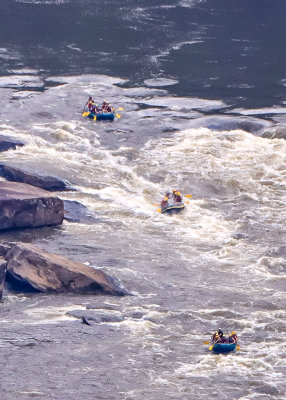 Rafters shoot the rapids as seen from the Canyon Rim Visitor Center in New River Gorge National Park