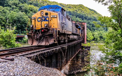 CSX train rumbles through the railroad bridge over the New River in New River Gorge National Park