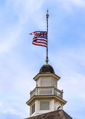 Flag flying over the Capitol Building clock tower in Colonial Williamsburg