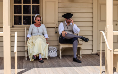 Residents on the porch of the R. Charlton Coffeehouse in Colonial Williamsburg