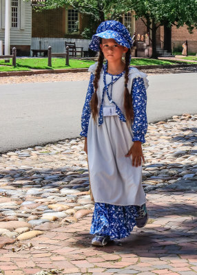 Young girl walking along Duke of Gloucester Street in Colonial Williamsburg