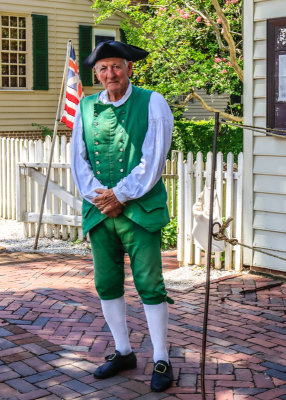 Man in front of his business on Duke of Gloucester Street in Colonial Williamsburg