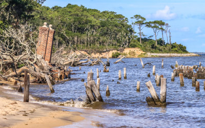 Beach erosion around a garden gate on the edge of Fort Raleigh NHS