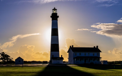 The Bodie Island Lighthouse silhouetted by the rising sun in Cape Hatteras NS