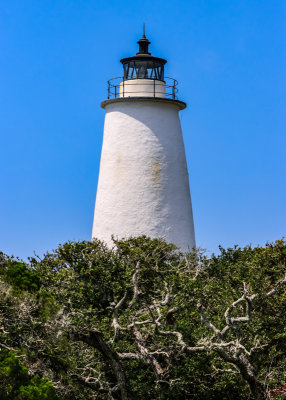 Closeup of the Ocracoke Lighthouse, above the trees, in Cape Hatteras NS