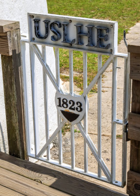 1823 gate with United States Lighthouse Establishment (USLHE) initials at the Ocracoke Lighthouse in Cape Hatteras NS