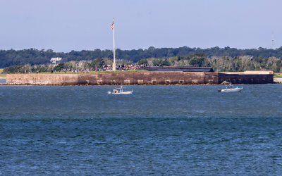 Fort Sumter morning flag raising as seen from Fort Moultrie in Fort Sumter National Monument