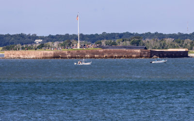 Fort Sumter morning flag raising as seen from Fort Moultrie in Fort Sumter National Monument