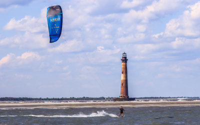 Wind surfer frames the Morris Island Lighthouse from the Lighthouse Inlet Heritage Preserve near Charleston South Carolina