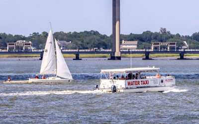 A Water Taxi glides by a small sailboat in Charleston Harbor near Charleston South Carolina
