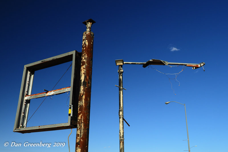 Old Sign Posts, Street Light and a Single Cloud