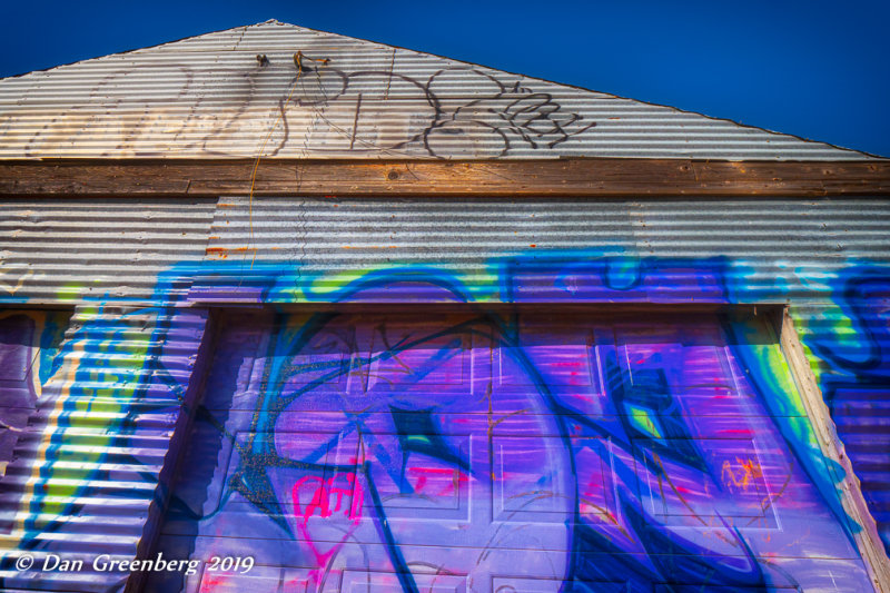 Vibrant Graffiti on Corrugated Metal