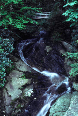 Mountain Foot Bridge over Waterfall