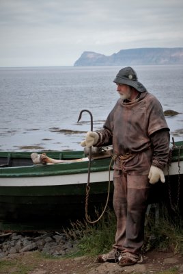Guide in front of very old boat in authentic clothing & hook. Guide interpreted for us.