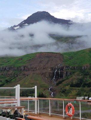 Mountains, fog, railings, waterfall from ship