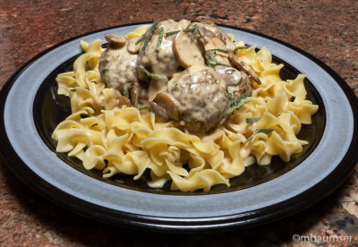 Meatballs in brandy cream sauce over noodles