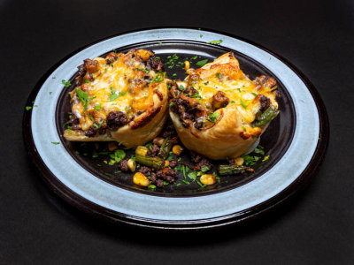 Bison hash in a puffy pastry cup with cheese.