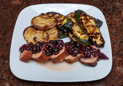 Pork tenderloin with blueberry bacon compote and grilled potatoes and zucchini