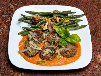 Meatballs in roasted red pepper sauce. Roasted green beans with garlic and walnuts.