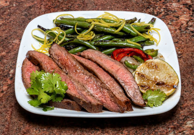Southwest Grilled Flank Steak on a bed of Onions and Peppers, Grilled Green Beans with Lemon Vinaigrette