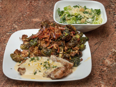 Grilled Chicken Breast in Lemon Cream Sauce, Fried Brussel Sprout leaves with Bacon Vinaigrette, And side Caesar Salad