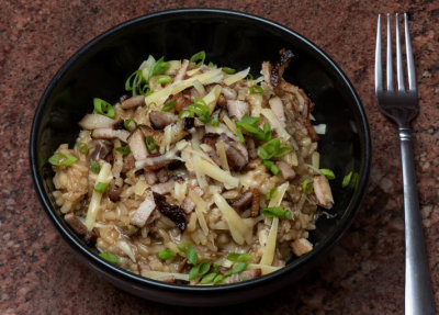 Duck Confit Risotto topped with crispy smoked pork belly, Gruyere cheese and green onions