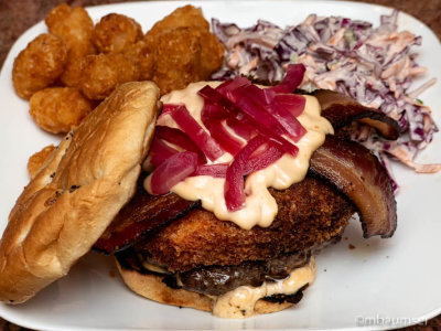 Burger/Fried Mac&Chez/Home Cured Bacon/Habanero Mango Mayo/Pickled Onions on an Onion roll with Coleslaw and Tater Tots