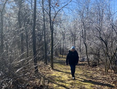 Brenda walking in the ice covered woods