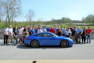 Porsche of Silver Spring's invited guests stand behind a Sapphire Blue Metallic 2018 Porsche 911 4S. (2767)