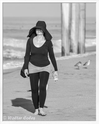 Lady walking beach in black 10-27-15 CC AI BW Frame w.jpg