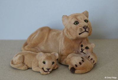 Flocked lioness and cubs figurines