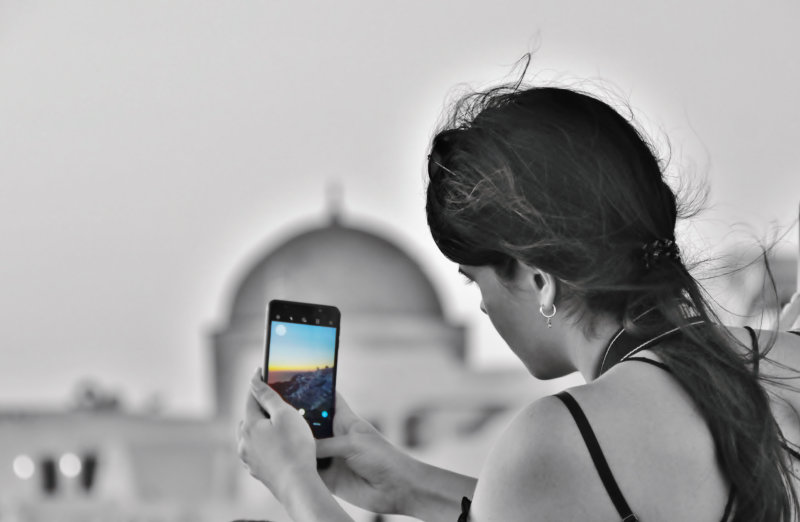 Danai having a sunset photo at Oia, Santorini.