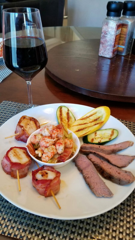 Sous Vide Steak, Bacon Wrapped Scallops, Sauted Cabbage with Langastino and Grilled Veggies