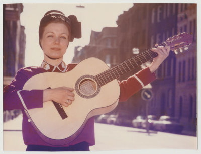 Carina Lingblom Wiik in Salvation Army uniform playing guitar, April 1981