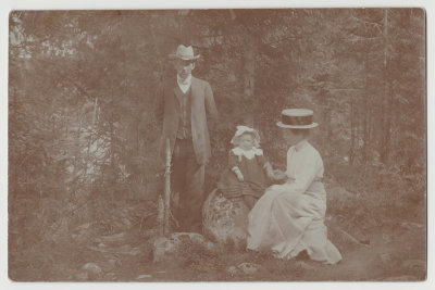unknown man, woman and child in woods, formal dress