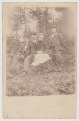 Unknown, 3 men, one woman holding spruce bough