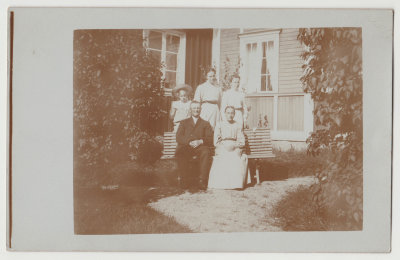 Unknown family in front of house
