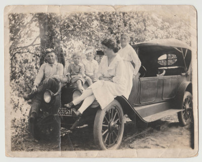 Oberg family on car, approx 1920. John, Dave, Katherine, Clara and Karin.