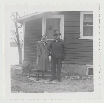 Clara and John Oberg in front of Spirit Lake cabin, 3/15/1958
