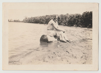 Katherine Van Fleet sitting on log at Lake
