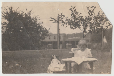 Katherine Oberg having tea with doll, 1914