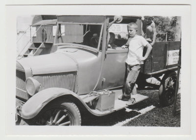 boy on truck running board