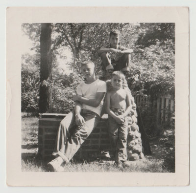 Bob Van Fleet, Chuck ? , and friend sitting on brick grill