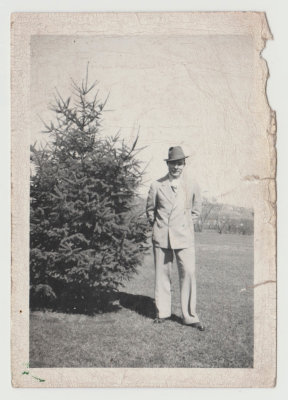 Harold Van Fleet standing next to evergreen tree