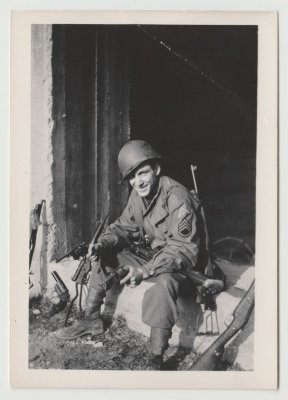 Duane Richards in military uniform with guns